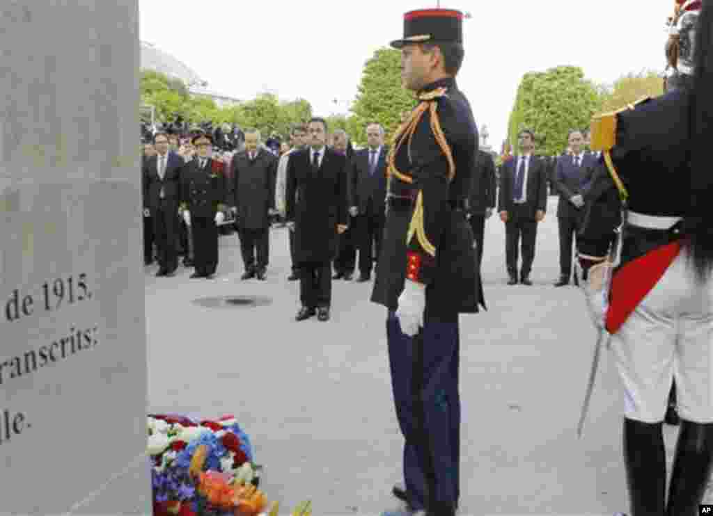 French President and candidate for the French presidential election Nicolas Sarkozy , center, stands before the Armenian Monument during a ceremony marking the 97th anniversary of the Armenian genocide, Tuesday, April. 24, 2012. (AP Photo/Jacques Brinon,