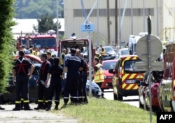 French police and firefighters gather at the entrance of the U.S.-based Air Products company in Saint-Quentin-Fallavier, near Lyon, central eastern France, June 26, 2015.