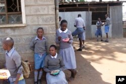 Pupils take a break at Mariakani Primary School in Nairobi, Kenya, July 27, 2015.