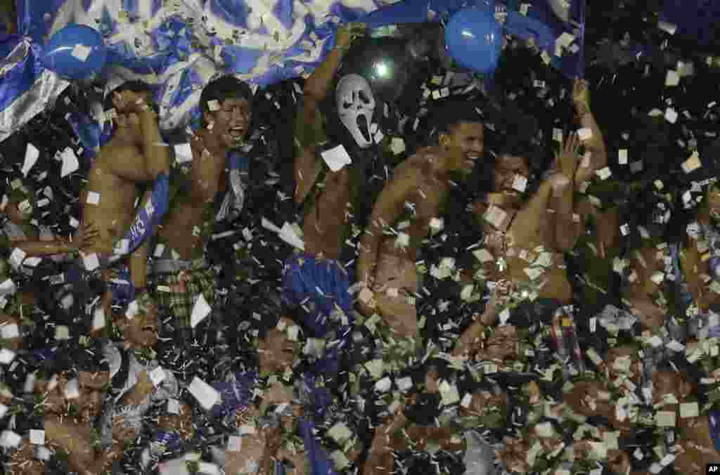 Ecuador’s Emelec fans cheer for their team during a Copa Sudamericana soccer match in Guayaquil, Ecuador, Nov. 5, 2014.