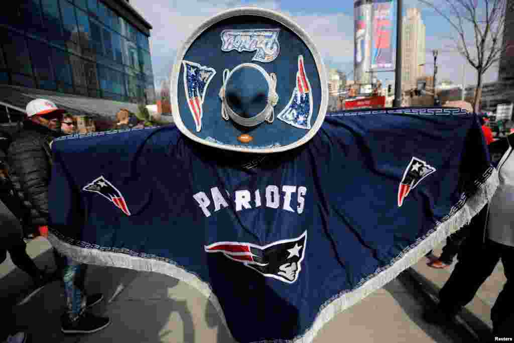 A New England Patriots fan wears a Patriots decorated sombrero and poncho during an NFL fan celebration in Centennial Park outside Mercedes Benz Stadium ahead of Super Bowl LIII in Atlanta, Feb. 2, 2019.