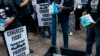 AIDS activists pour cat litter on an image of Turing Pharmaceuticals CEO Martin Shkreli in a makeshift cat litter pan during a protest highlighting pharmaceutical drug pricing, in front of the building that houses Turing's offices, in New York.