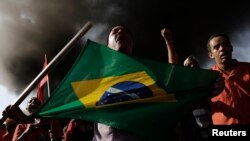 Thành viên của Phong trào Công nhân Vô gia cư sống gần sân vận động World Cup ở Sao Paolo chặn một con đường để phản đối chi phí lớn lao đổ vào để tổ chức World Cup