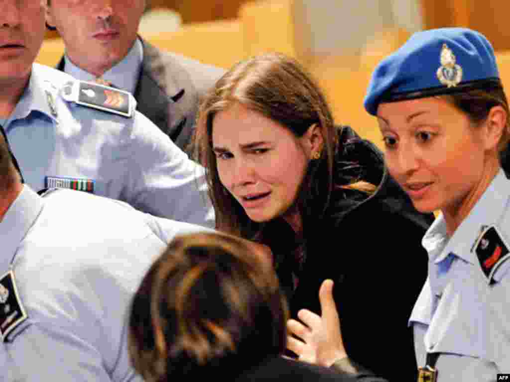 Amanda Knox cries following the verdict that overturns her conviction and acquits her of murdering her British roomate Meredith Kercher, at the Perugia court, Italy, Monday Oct. 3, 2011. An Italian appeals court has thrown out Amanda Knox's murder convict