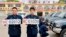 Officers of China's navy pose for photographs with the new (L) and old military car licence plates, in Qinhuangdao, Hebei province Apr. 28, 2013.
