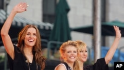 FILE - Emily Robison, Natalie Maines and Martie Maguire, members of The Dixie Chicks, wave to the crowd as they perform on ABC's "Good Morning America" concert series in Bryant Park, in New York, May 26, 2006. The band has changed its name to The Chicks.