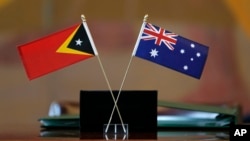 Bendera Timor Timur, kiri, dan Australia dikibarkan dalam upacara di markas besar PBB, Selasa, 6 Maret 2018. Australia akan mengeluarkan $23 juta untuk mendukung polisi Timor Leste. (Foto: AP)