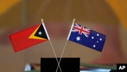 The flags of East Timor, left, and Australia are displayed during a ceremony at United Nations headquarters, Tuesday, March 6, 2018. 