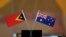 The flags of East Timor, left, and Australia are displayed during a ceremony at United Nations headquarters, Tuesday, March 6, 2018. 