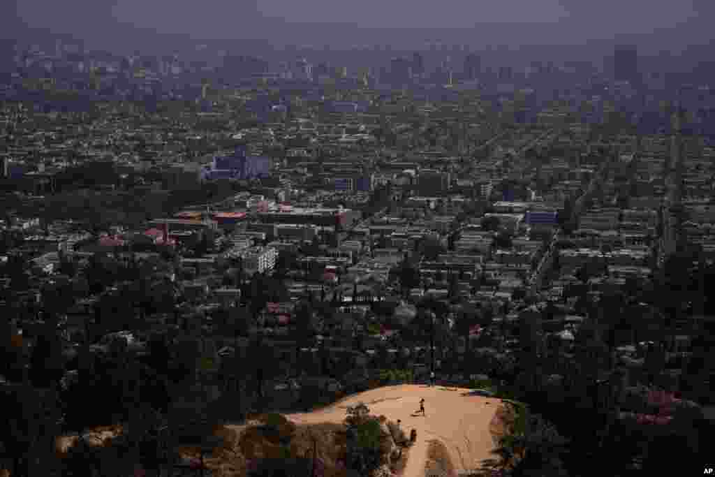 A jogger runs along a Griffith Park trail in Los Angeles, California, May 3, 2021.&#160;&#160;Los Angeles County is expected to move into the least-restrictive yellow tier this week, amid the coronavirus pandemic.