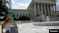 2014年6月25日，一位妇女在华盛顿美国最高法院外面使用手机 