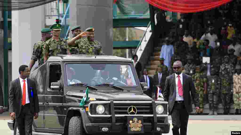 President Jonathan salutes as he parades during the Nigeria Army&#39;s 150th anniversary celebration.