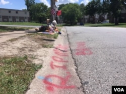 The location of Michael Brown's death on Canfield Drive in Ferguson, Missouri, is a now a makeshift memorial on the anniversary of the incident, August 11, 2015. (Victoria Macchi/VOA)