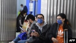 Passengers wearing protective masks are seen at the International Airport in Mexico City, Mexico, Feb. 28, 2020.