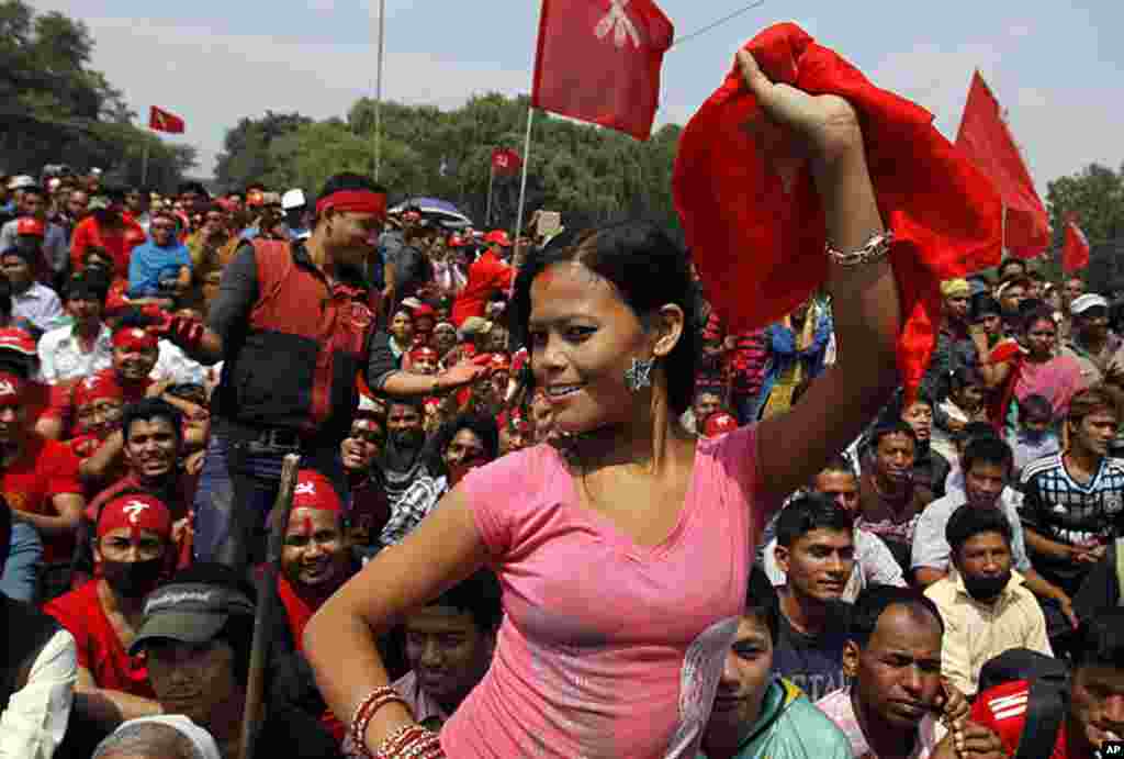 A trade union activist dances during a rally organized by various trade unions affiliated to the Unified Communist Party of Nepal (Maoist) to mark May Day in Katmandu, Nepal, May 1, 2012. (AP Photo)