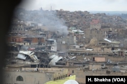 Mosul's Old City, seen through a sniper hole on the outskirts, is the scene of some of the fiercest fighting since operations to retake the city from IS militants began in October. Mosul, March 25, 2017.