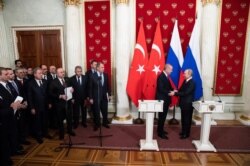 블라디미르 푸틴 러시아 대통령과 레제프 타이이프 에르도안 터키 대통령이 5일 모스크바에서 시리아 북서부 휴전에 합의한 후 공동기자회견에서 악수하고 있다.