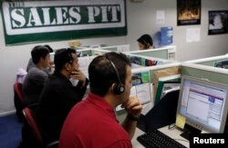 FILE - Call center agents work overnight daily to cater to U.S. clients in Manila's Makati financial district, Feb. 6, 2012.