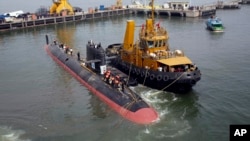 The INS Kalvari, one of the six Scorpene diesel-electric attack submarines, is set afloat at the naval dockyard in Mumbai, India, Thursday, Oct. 29, 2015. 