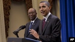 U.S. Trade Representative Ron Kirk, left, looks on as President Barack Obama talks about the US-Korea Free Trade Agreement on Saturday, Dec. 4, 2010 in Washington. (AP Photo/Evan Vucci)