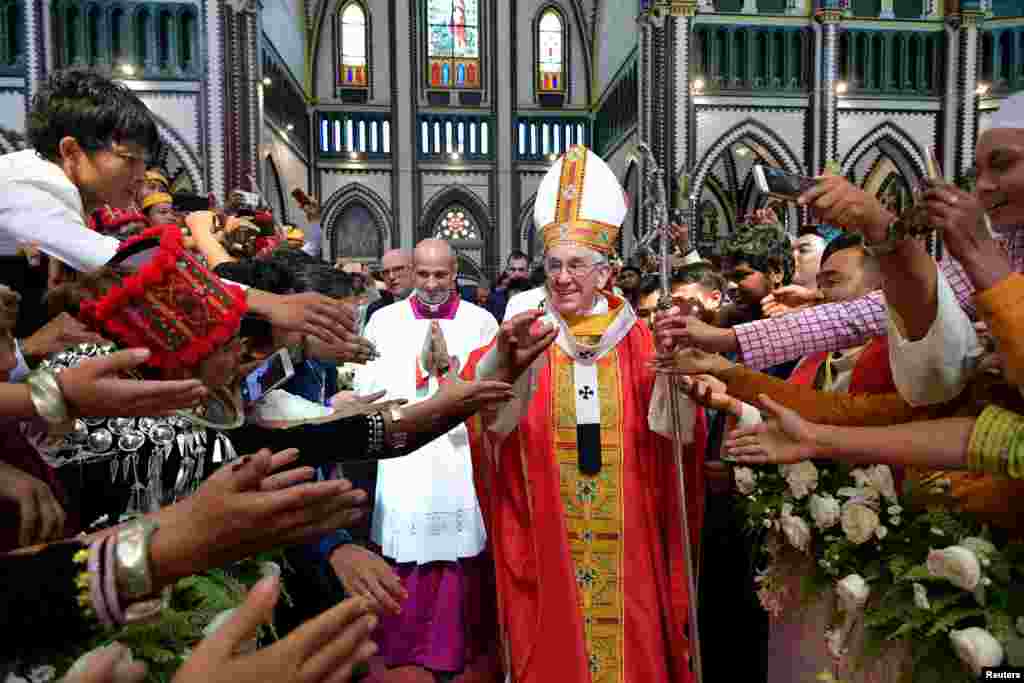 Pope Francis arrives to leads a Mass at St Mary's Cathedral in Yangon