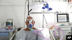 A patient breathes through an oxygen mask at the COVID-19 ICU unit of the Dr. Abdulah Nakas General Hospital in Sarajevo, Bosnia.