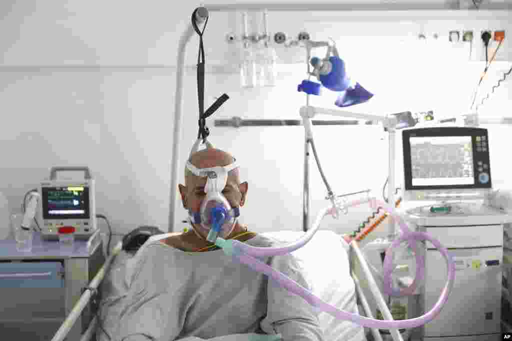 A patient breathes through an oxygen mask at the COVID-19 ICU unit of the Dr. Abdulah Nakas General Hospital in Sarajevo, Bosnia.