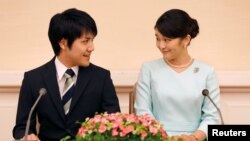 Princess Mako, the elder daughter of Prince Akishino and Princess Kiko, and her fiancee Kei Komuro, a university friend of Princess Mako, smile during a press conference to announce their engagement at Akasaka East Residence in Tokyo, Japan, Sept. 3, 2017