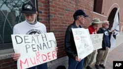 FILE- A group from "Veterans for Peace" picket outside the Moakley Federal Courthouse as inside jury deliberations continue in the penalty phase of the trial of Boston Marathon bomber Dzhokhar Tsarnaev, May 15, 2015. 