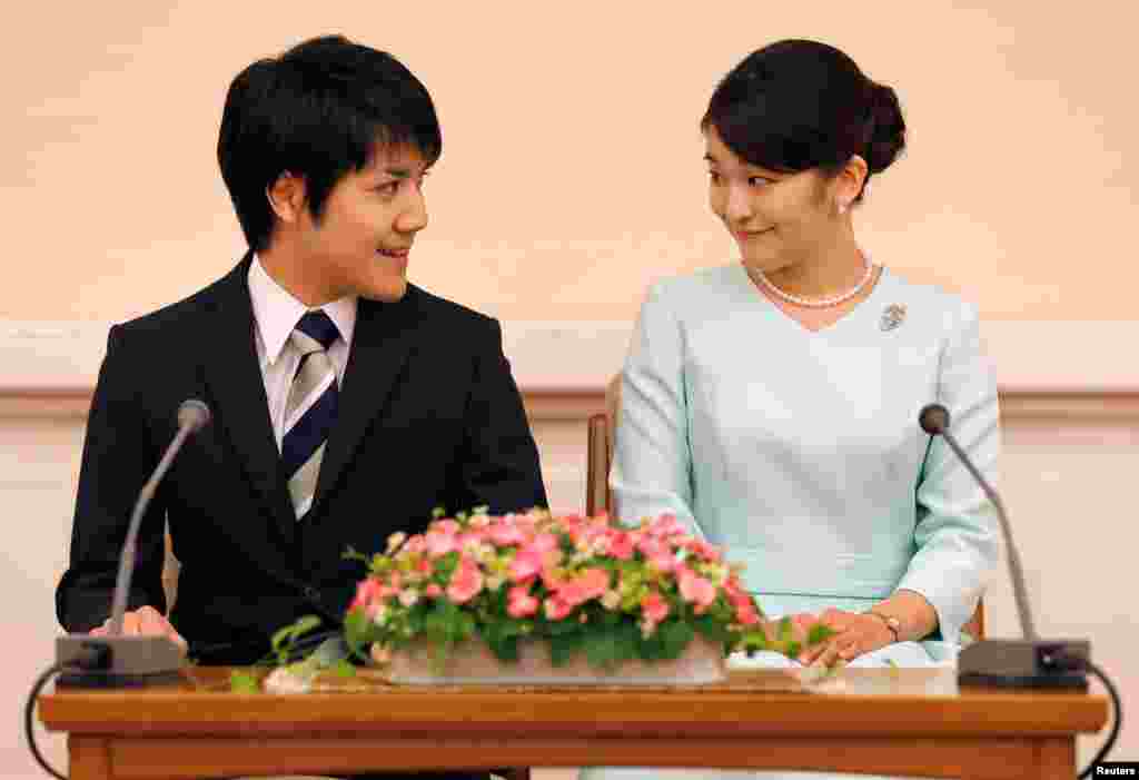 Princess Mako, the elder daughter of Prince Akishino and Princess Kiko, and her fiancee Kei Komuro, smile during a press conference to announce their engagement at Akasaka East Residence in Tokyo, Japan.