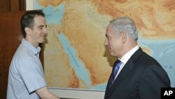 In this photo released by the Israeli Government Press Office Ilan Grapel (l) is greeted in Jerusalem by Israel's Prime Minister Benjamin Netanyahu, Oct. 27, 2011