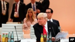 FILE - U.S. President Donald Trump sits in front of his delegation as he attends a working session at the G-20 summit in Hamburg, Germany, July 8, 2017. The financial leaders of the world's 20 biggest economies will meet in Buenos Aires July 21-22, 2018. 
