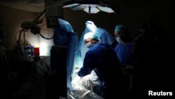 FILE - Doctors treat a patient during a pilot of an Israeli-developed photodynamic therapy to kill prostate cancer tumors in patients, at an operating room in Ramat Aviv Medical Center's Urology department in Tel Aviv, Israel, May 5, 2016.