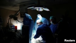 FILE - Doctors treat a patient during a pilot of an Israeli-developed photodynamic therapy to kill prostate cancer tumors in patients, at an operating room in Ramat Aviv Medical Center's Urology department in Tel Aviv, Israel, May 5, 2016.