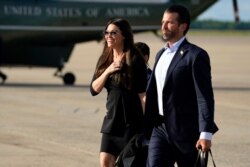 Donald Trump Jr., walks with his girlfriend Kimberly Guilfoyle after arriving at Andrews Air Force Base, Md., after traveling to Florida, with President Donald Trump, May 27, 2020.