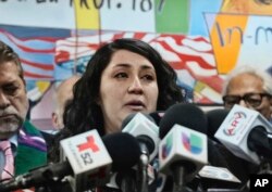 Melissa Castro weeps as she talks about her husband, Jose Luis Ibarra Bucio, during a news conference at the offices of the Coalition for Humane Immigrant Rights of Los Angeles, April 10, 2019, in Los Angeles.