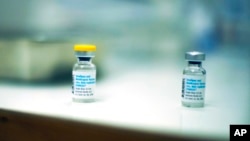 Empty vials of vaccines against Monkeypox lie on a table after being used to vaccinate people at a medical center in Barcelona, Spain, Tuesday, July 26, 2022. (AP Photo/Francisco Seco)