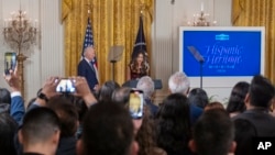 FILE - President Joe Biden listens to actress Jessica Alba speak during a reception at the White House in celebration of the Hispanic Heritage Month to honor the contributions of the Latino community to the United States, Sept. 18, 2024.