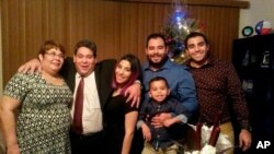 FILE - This December 2015 family photo shows Jose Pereira, second left, one of the Houston-based Citgo oil executives convicted and ordered to prison in Venezuela, pictured with his family in Houston, Texas.
