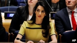 FILE - International human rights lawyer Amal Clooney waits to speak at an event at United Nations headquarters in New York, March 9, 2017. 