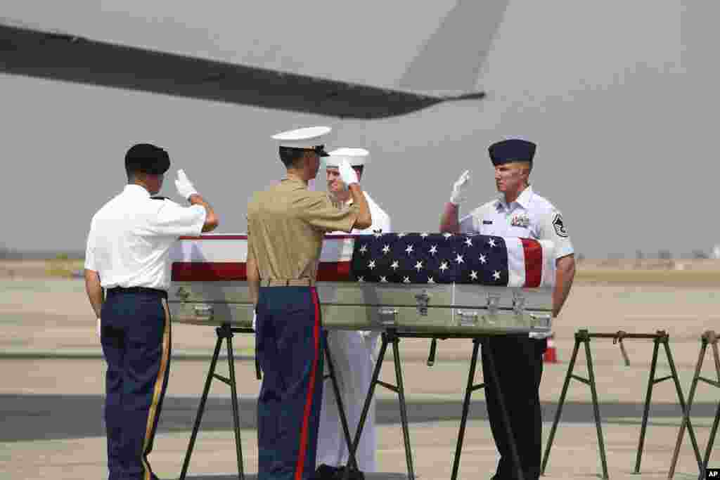 U.S. military guard of honor salute a coffin covered with the American flag during a repatriation ceremony at Mandalay International Airport in central Myanmar. The U.S. military has repatriated what may be the remains of service members who were lost in action during World War II.