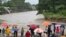 People look at a flooded creek near San Pedro Sula, Honduras, on Nov. 16, 2024.
