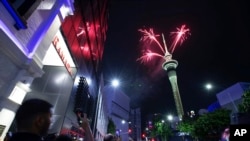 Fireworks burst from the Sky Tower in Auckland, New Zealand, to celebrate the New Year on January 1, 2024.