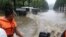 A boat goes pass a flooded street in Anju City, South Phyongan Province, in North Korea, July 30, 2012. 