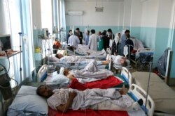 Wounded men receive treatment in a hospital after a powerful bomb blast in Kabul, Afghanistan, July 1, 2019.