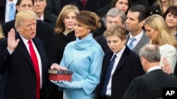 Donald Trump is sworn in as the 45th president of the United States by Chief Justice John Roberts as Melania Trump looks on during the 58th Presidential Inauguration at the U.S. Capitol in Washington, Jan. 20, 2017. 