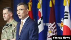 South Korean Defense Ministry's Deputy Minister for Policy Yoo Jeh-seung, right, speaks to the media about deploying the Terminal High-Altitude Area Defense, or THAAD, as Lt. Gen. Thomas Vandal, the commander of U.S. Forces Korea's Eighth Army, left, also answers questions. 