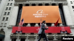 FILE - Signage for Alibaba Group Holding Ltd. covers the front facade of the New York Stock Exchange, in Manhattan.