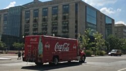 A Coca-Cola delivery truck drives past an office building in Washington, DC. (Photo: Diaa Bekheet)