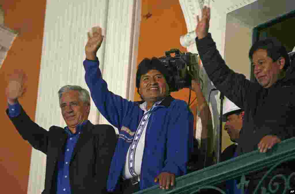 Bolivia's President Evo Morales greets supporters from the balcony of the presidential palace in La Paz, Oct. 12, 2014. 
